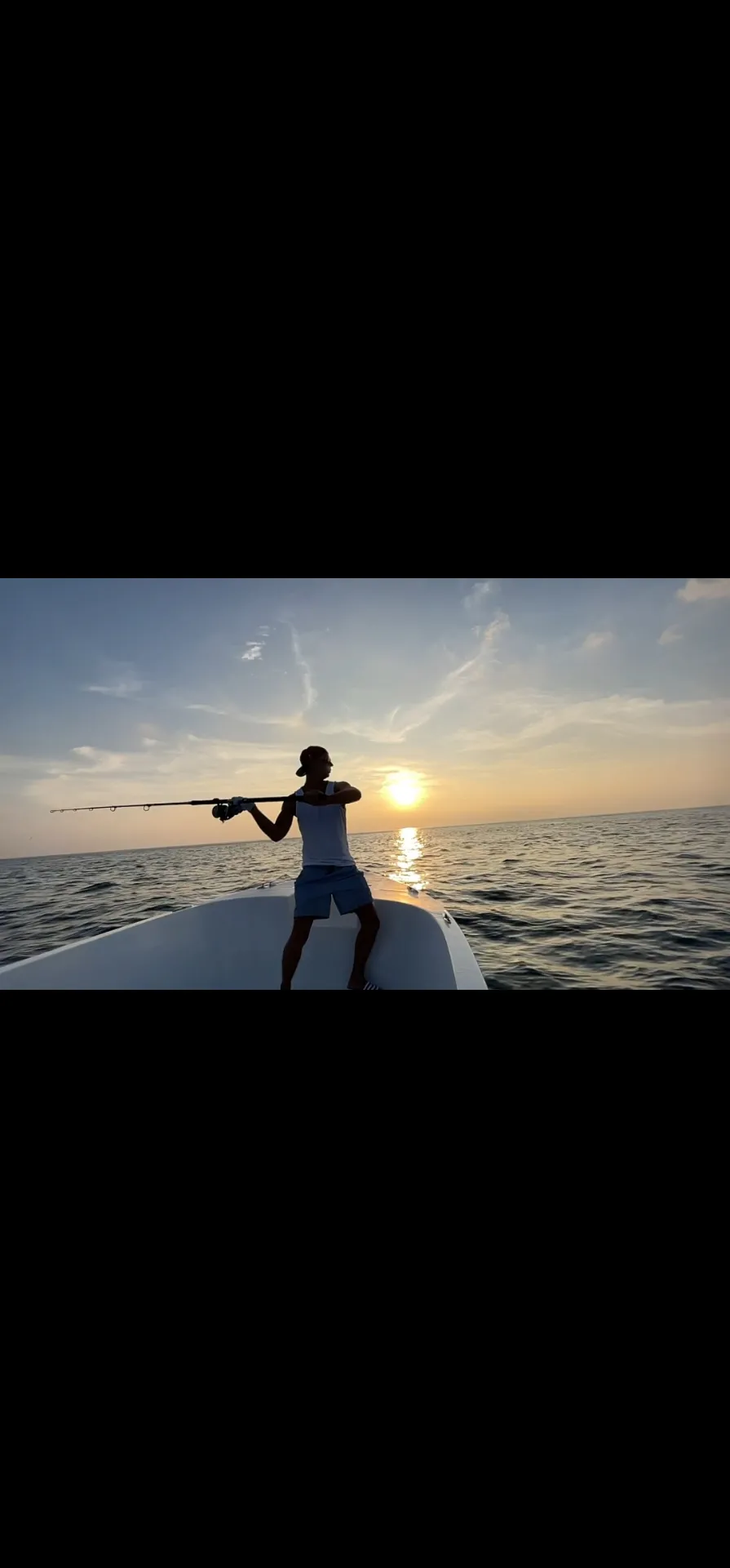 Local Maldivian captain steering a boat at sunset