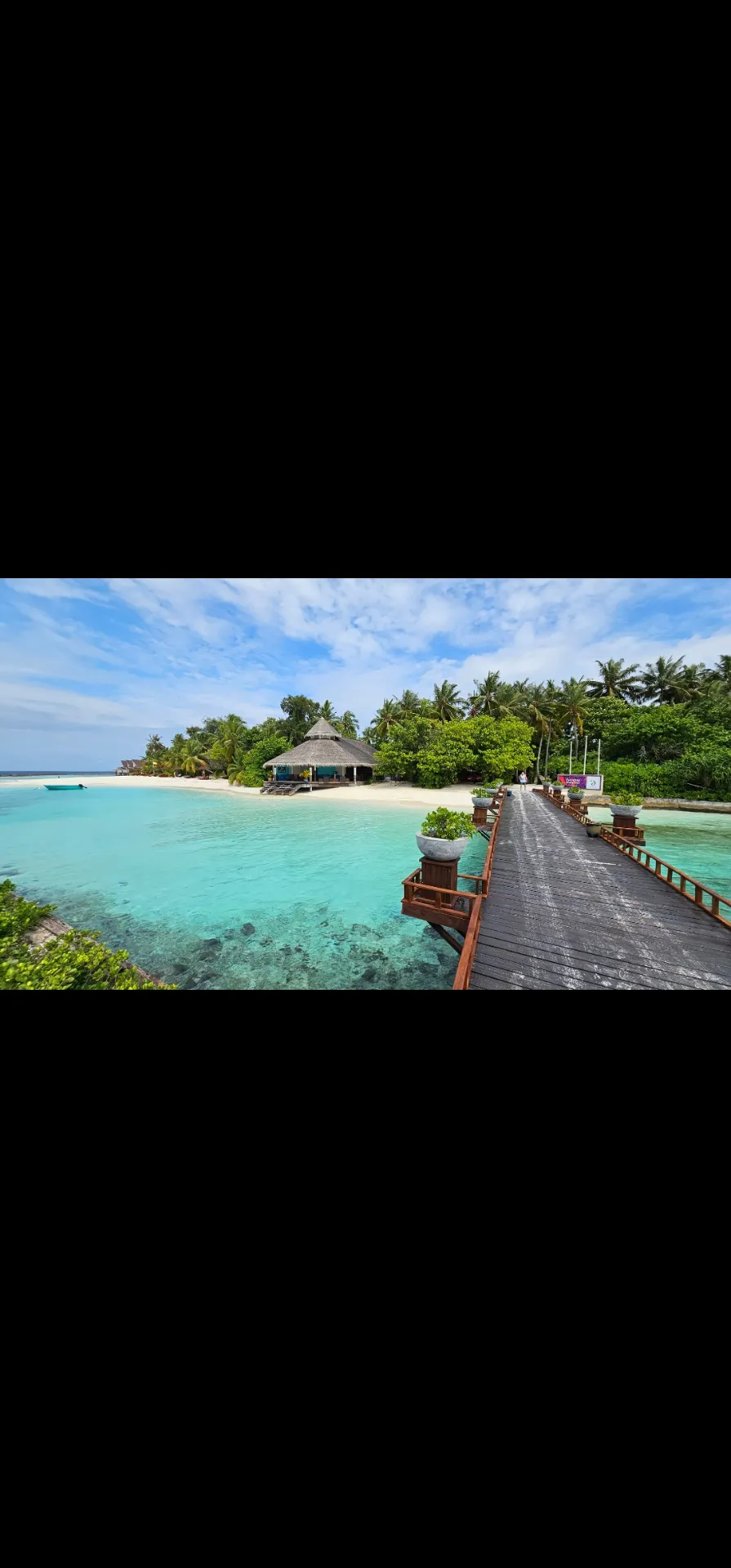 Tropical Maldivian island surrounded by turquoise water